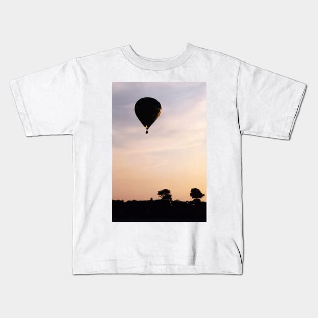 Hot Air Balloon flying during a summer evening Kids T-Shirt by richflintphoto